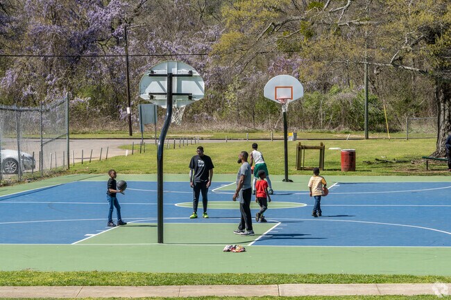 Families playing on the basketball court in Grayson Park in Birmingham, AL.