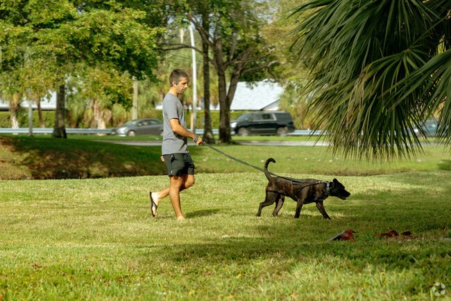 A man walks his dog in New River Estates in Sunrise, FL.