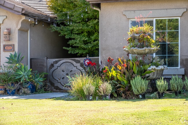 Enjoy beautiful landscaping at the entrance of a single-family home in Hampton Woods.