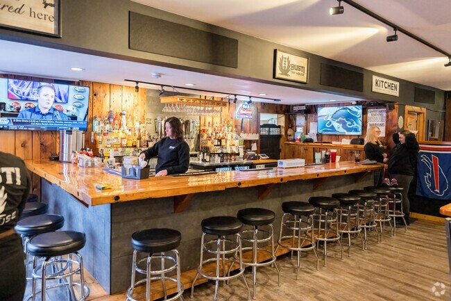 The bar at Busti Tap House offers a warm setting for enjoying drinks and hearty meals with friends.