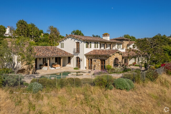 A luxury home in Shady Canyon that features a pool and has canyon views.
