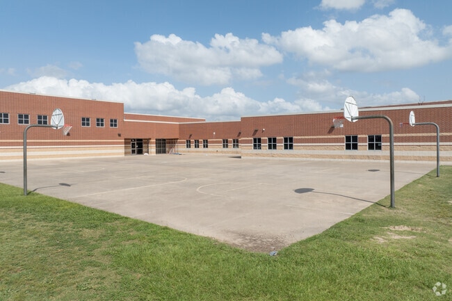 The school's spacious campus offers modern facilities for learning and play.