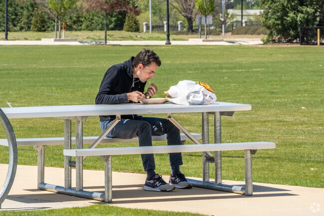 A local Mayfair-Piedmont resident enjoys a sandwich in the park.