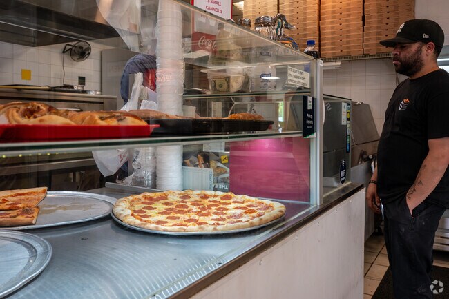 Enjoy a fresh slice of pizza at Nino's Pizzeria located adjacent to Lockhart.