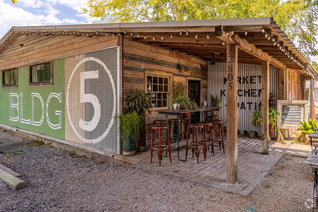 BLDG 5 offers outdoor seating under tall oaks and sparkling lights in the Garden District.