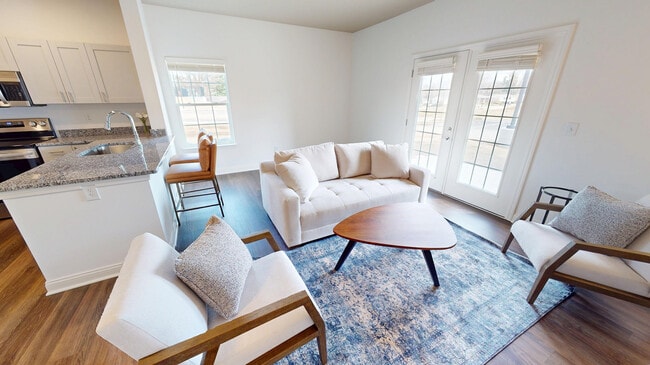 The Jane living room is spacious with double doors to the private patio/balcony.