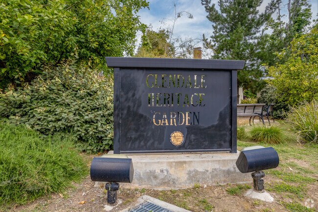 The Glendale Heritage Garden sign welcomes visitors with its charming rustic design and elegant lettering.