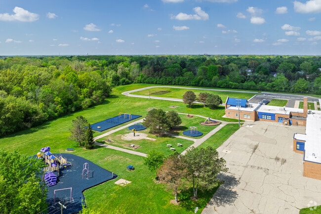 Weston Elementary School features a large play area behind the school for student recess.