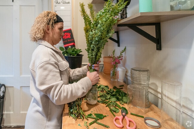 A florist at Petal and Wren in Monson prepares a bouquet.