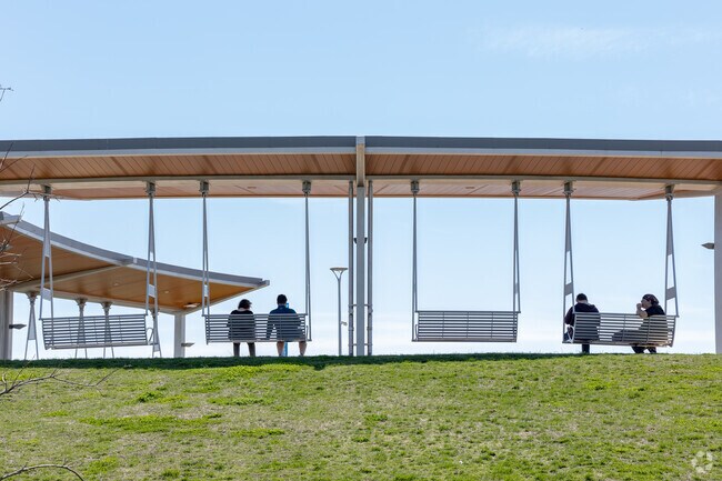 Evansville visitors grab a seat on the swing benches at Sunset Park.