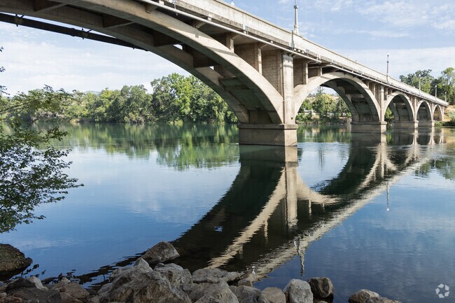 You can reach out and touch the Sacramento River in Redding, California.