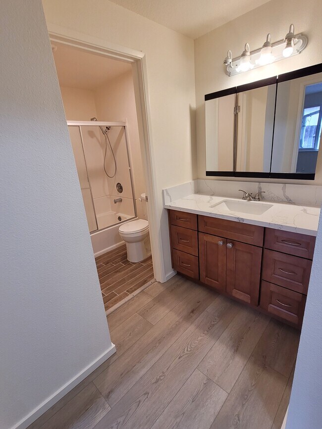 Separate vanity space from shower/toilet area.