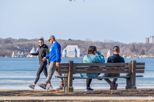 People walking and enjoying the lake view in the Lynnhurst neighborhood.