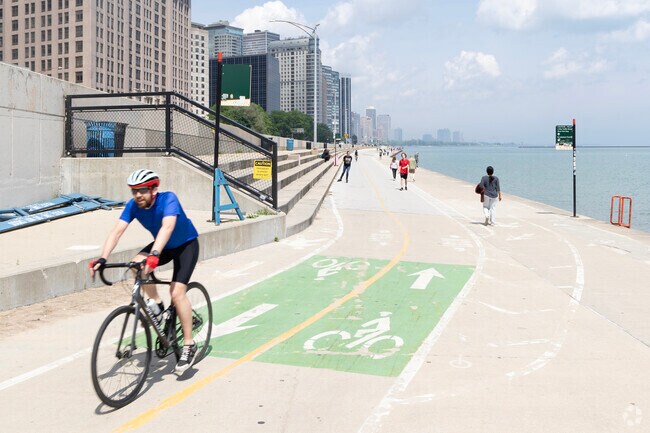 Bikers race down the lake shore path as it runs through Jane Adams Memorial Park.