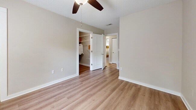 Unwind in the Jekyll master bedroom with elegant wood-styled floors and enjoy the vast walk-in closet adorned with customized shelving.