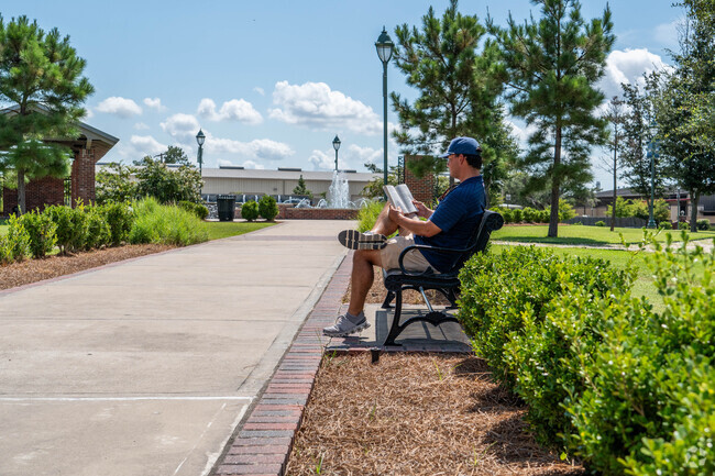 A man reads a book at a quiet bench Beverly Hills' Center Circle Park.