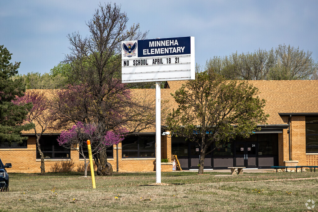 There is a sign for Minneha Core Knowledge Elementary School near the main road.