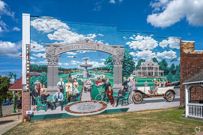 A colorful mural depicts the life and times of Sebring.