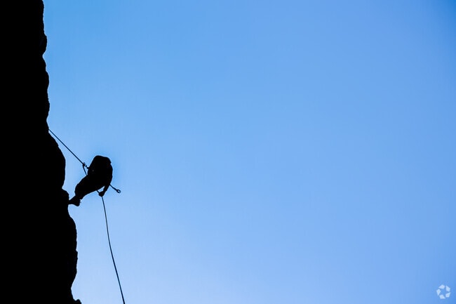 A rock climber's silhouette is seen belaying off of an Alpine Meadows crag.