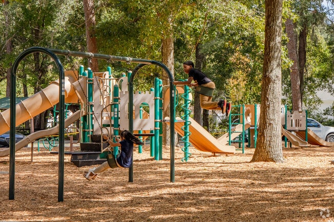 Macon Community Park playground features shaded equipment and open space for kids to explore.