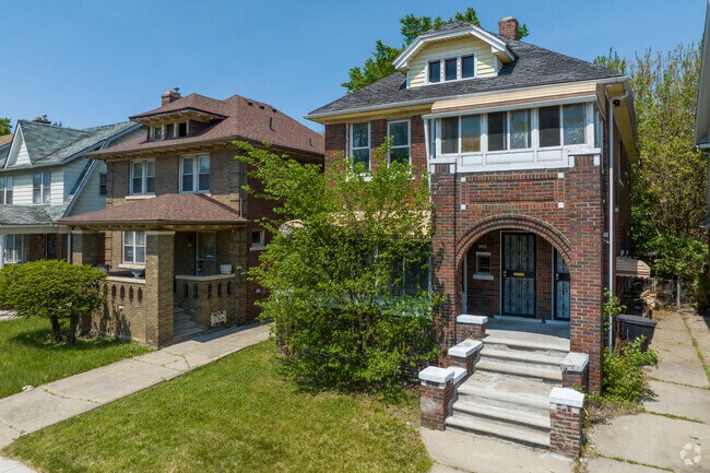 Drive past brick duplexes with grand porches in West Oakman Boulevard