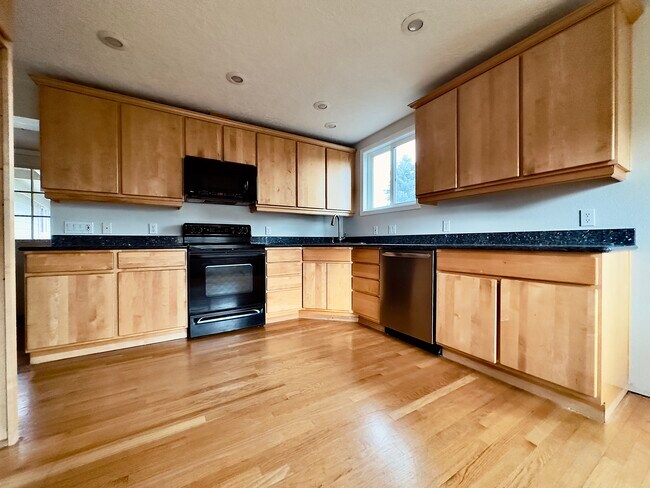 Kitchen. Solid wood cabinets and oak flooring