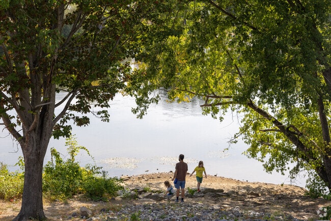 There are some shaded sandy areas along the Downtown Auburn Riverwalk.