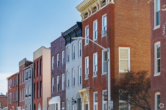 Some residents elect to color traditional brick row-home in bright colors in Sharp-Leadenhall.