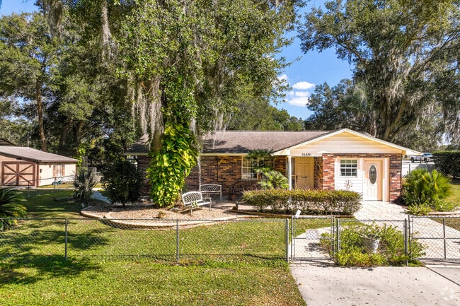 An old fashioned ranch style home with a large backyard and shed in Summerfield, Fl.