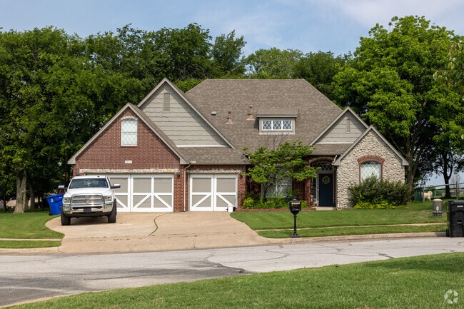 Within Battle Creek neighborhood, a stunning stone home captivates with timeless elegance.