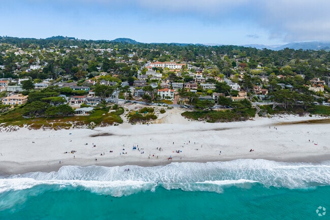 Folks gather on the beach for an iconic day in the emerald sea in Carmel-By-The-Sea, California.