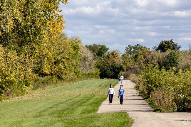 Two young boys enjoying their walk on a path along the lake at the Cornerstone Lakes Park.