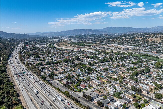 The elevated 5 freeway borders Elysian Valley with lush foliage and accessibility.