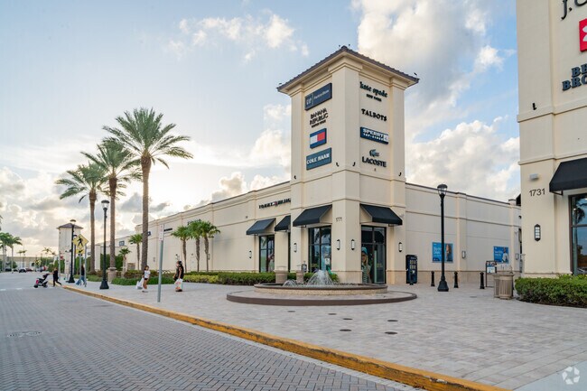 Retail storefronts at Tanger Outlets near Lake Belvedere Estates.