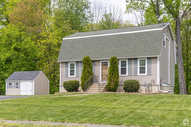 A small ranch style home with a gambrel roof in the Bradford Greens neighborhood