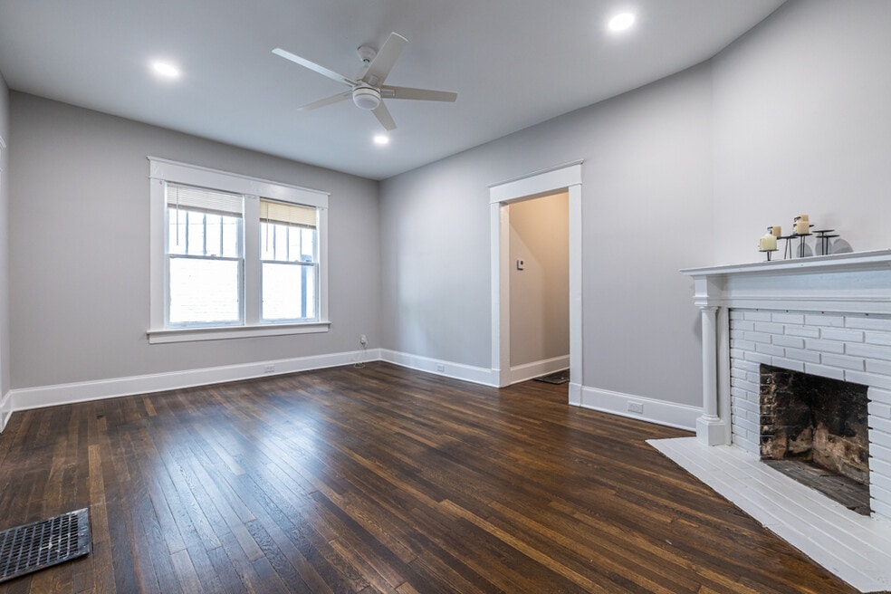 Spacious front room with decorative fireplace