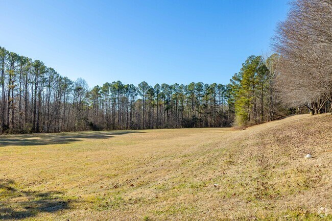 Dickson Elementary School has a large tree lined green space for outdoor activities in Dickson.