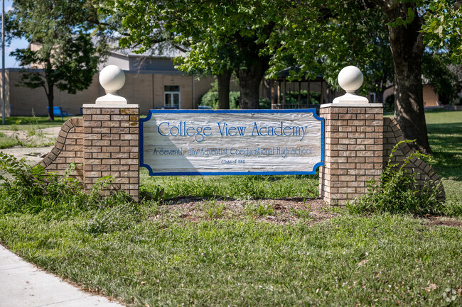 There is a brick sign near the entry of College View Academy.