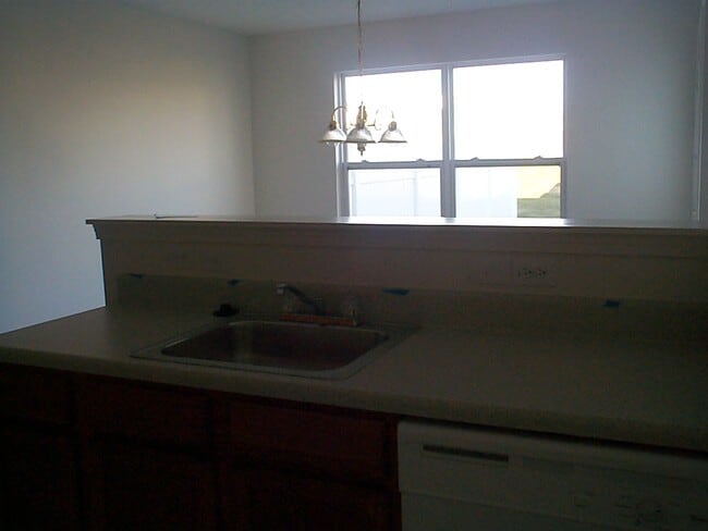 Kitchen Note this pic was taken before the walls were painted and the backsplash was added behind the sink.