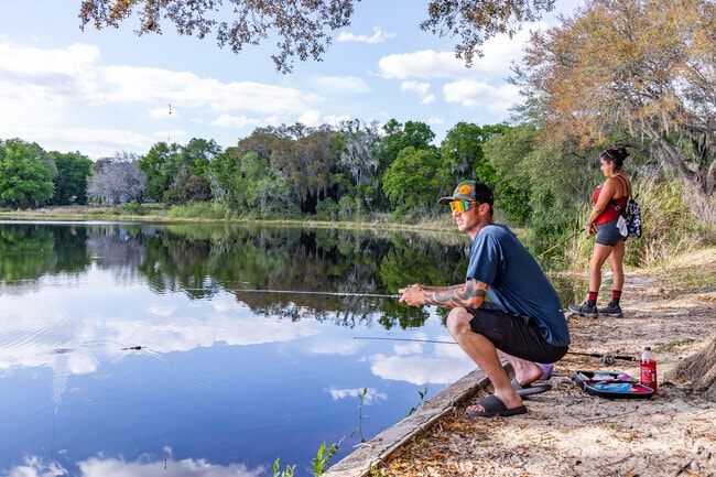 A young couple hopes for the big catch fishing on Sunset Lake in Mascotte.
