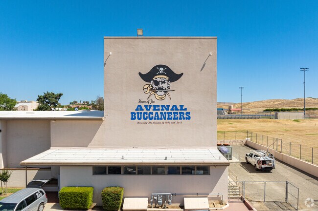 A large mural of the Avenal High School mascot is featured on a large building.