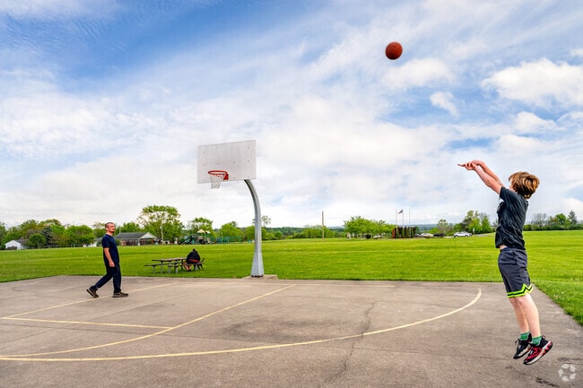 A Euclid-Heights-Runnymede family shoots some hoops at Jacot Park.