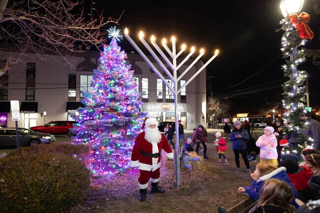 Santa helps illuminate the Christmas Tree and Menorah in Merrick.