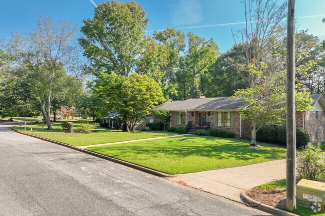 Homes in Cloverleaf often feature lush green lawns and tall trees.