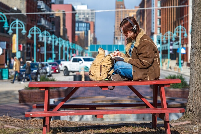 An art student sketching at the Third Wards Catalano Square Park.