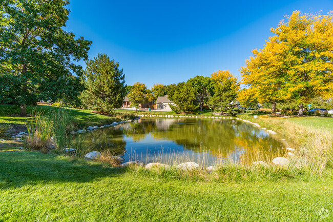 Clarendon Hills is a beautiful neighborhood that features ponds, tall trees, and green grass.