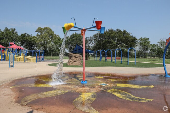 Kids love standing under the buckets on the splash pad at Bentley Park Sports Complex.