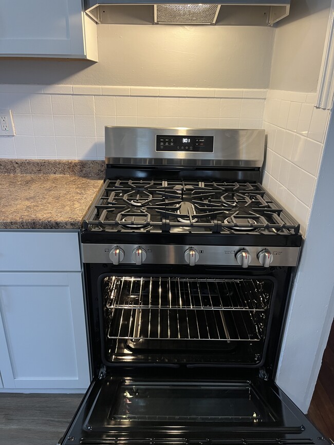 New SS self-cleaning gas stove.