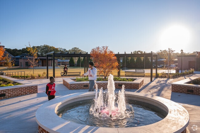 Locals enjoy the newest park built in downtown Monroe with a fountain and amphitheater.