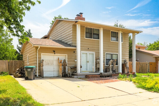 This two-story home in Indian Hills Riverbend has some unique statue figures in the front yard.
